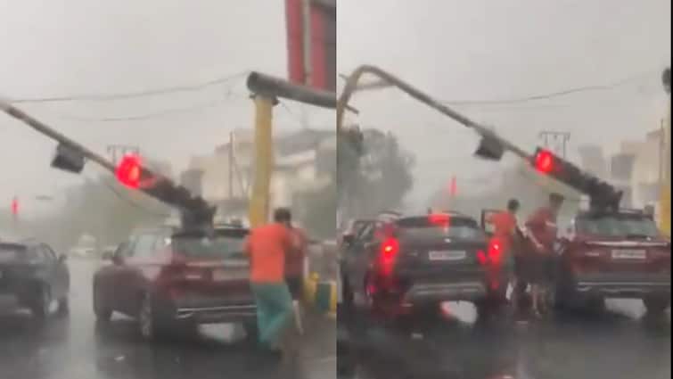 Noida rain after storm traffic light pole fell on a car at DM intersection ann नोएडा में तेज आंधी के बाद बारिश, DM चौराहे पर गाड़ी के ऊपर गिरा ट्रैफिक लाइट का खंभा
